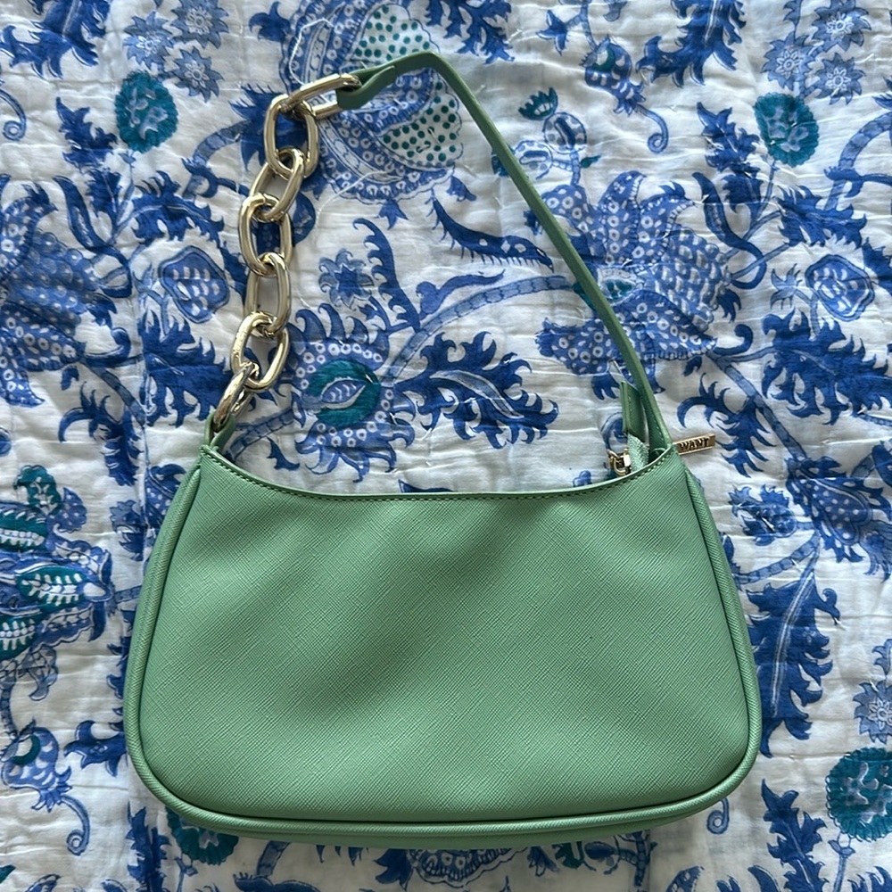 Mint green hand bag with chain handle. Has a card holder and one pocket inside.